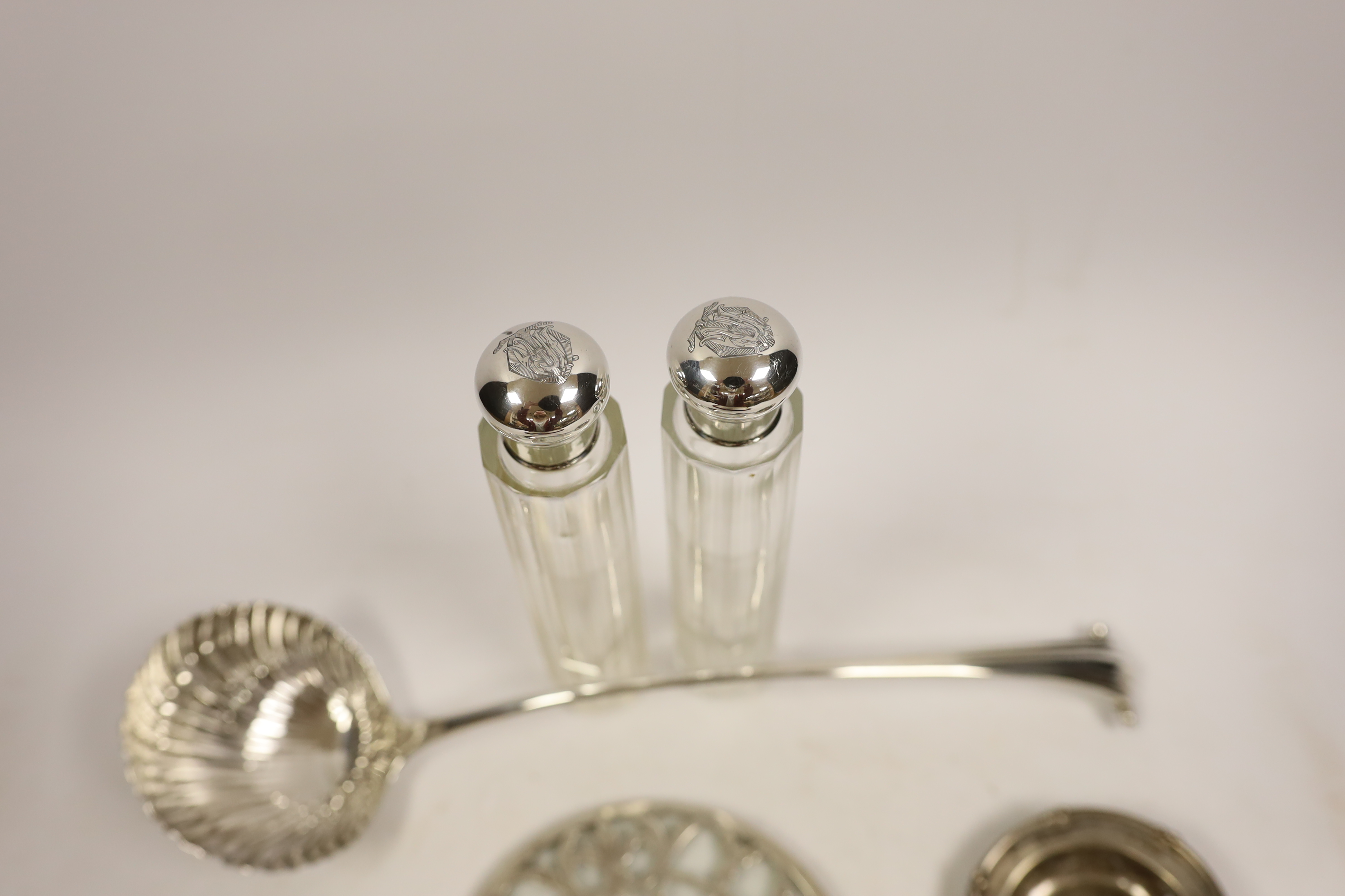 An 18th century silver base mark Onslow pattern soup ladle, indistinct marks and five other items including a silver mounted glass hip flask and a silver tea strainer with wooden handle.